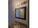 Bathroom featuring a granite countertop, undermount sink, and modern light fixture at 5248 Greene Ln # B, Las Vegas, NV 89119
