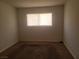 Carpeted bedroom featuring a window for natural light at 5248 Greene Ln # B, Las Vegas, NV 89119