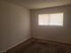 This bedroom offers neutral walls, carpet flooring, and a window with blinds for natural light at 5248 Greene Ln # B, Las Vegas, NV 89119