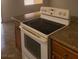Range and counter in a functional kitchen featuring granite counters and wood cabinets at 5248 Greene Ln # B, Las Vegas, NV 89119