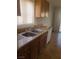 Close up on a kitchen sink, cabinets, window, and granite counters with tile floors at 5248 Greene Ln # B, Las Vegas, NV 89119