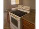 Kitchen range with granite counters and wood cabinets at 5248 Greene Ln # B, Las Vegas, NV 89119