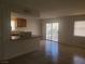Sunlit living area with bar-style dining, tiled floors, and sliding glass doors at 5248 Greene Ln # B, Las Vegas, NV 89119