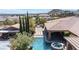 Aerial view of a home with backyard pool, spa, covered patio and mountain views in distance at 5410 Serenity Brook Dr, Las Vegas, NV 89149