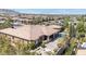 An aerial view of a single story home with a pool, spa, covered patio, and tile roof at 5410 Serenity Brook Dr, Las Vegas, NV 89149