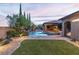 A serene backyard view showcases a pool, spa, and lush landscaping, ideal for relaxation and outdoor entertainment at 5410 Serenity Brook Dr, Las Vegas, NV 89149