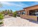 Backyard oasis featuring an outdoor kitchen, fireplace, and patio area for relaxing or entertaining at 5410 Serenity Brook Dr, Las Vegas, NV 89149