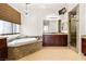 Luxurious bathroom with a large tub, granite counters, and separate shower at 5410 Serenity Brook Dr, Las Vegas, NV 89149