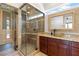 Spa-like bathroom featuring a glass-enclosed shower, a sauna, and a granite vanity at 5410 Serenity Brook Dr, Las Vegas, NV 89149