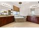 Spa like bathroom featuring a chandelier, granite counters and a soaking tub at 5410 Serenity Brook Dr, Las Vegas, NV 89149