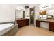 Bathroom includes granite counters, a separate shower, and a large soaking tub at 5410 Serenity Brook Dr, Las Vegas, NV 89149