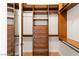A closet with wood shelving, drawers, and clothing bars for maximum storage at 5410 Serenity Brook Dr, Las Vegas, NV 89149
