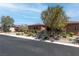Stunning exterior of home with lush landscaping, stone accents, and a private driveway at 5410 Serenity Brook Dr, Las Vegas, NV 89149
