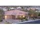 Beautiful single-story home featuring a three-car garage, stone details, and desert landscaping at 5410 Serenity Brook Dr, Las Vegas, NV 89149