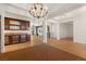 Spacious great room boasting a wet bar, beautiful chandelier, and an open floor plan at 5410 Serenity Brook Dr, Las Vegas, NV 89149