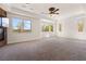 Spacious great room features neutral carpet, white trim, and many windows at 5410 Serenity Brook Dr, Las Vegas, NV 89149