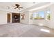 Bright great room features fireplace, TV, and large windows with backyard views at 5410 Serenity Brook Dr, Las Vegas, NV 89149