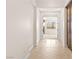 Elegant hallway view of bright great room with a stone fireplace and window views at 5410 Serenity Brook Dr, Las Vegas, NV 89149