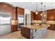 Beautiful kitchen with stone island, modern stainless steel refrigerator, and custom cabinetry at 5410 Serenity Brook Dr, Las Vegas, NV 89149