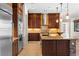 Elegant kitchen with an island, granite countertop, stainless steel appliances, and custom wood cabinetry at 5410 Serenity Brook Dr, Las Vegas, NV 89149