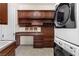 This is a laundry room with built in cabinets, counter space and shelving at 5410 Serenity Brook Dr, Las Vegas, NV 89149