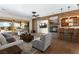 Inviting living room with stone accent wall, cozy fireplace, and convenient wet bar area at 5410 Serenity Brook Dr, Las Vegas, NV 89149