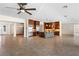 Spacious living area showcasing a modern kitchen island, stainless steel appliances, and elegant tile flooring at 5410 Serenity Brook Dr, Las Vegas, NV 89149