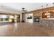 Large living room with fireplace, stone accent wall and a wet bar area at 5410 Serenity Brook Dr, Las Vegas, NV 89149
