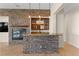 Living room wet bar with stone accents, great for entertaining guests near the fireplace and tv at 5410 Serenity Brook Dr, Las Vegas, NV 89149