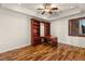 Well-appointed home office with hardwood floors, built-in bookshelves, and natural light at 5410 Serenity Brook Dr, Las Vegas, NV 89149