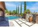Beautiful pool with water features and inviting lounge seating, perfect for relaxation at 5410 Serenity Brook Dr, Las Vegas, NV 89149