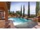 Stunning backyard pool featuring waterfalls, a spa, and elegant landscaping for serene outdoor living at 5410 Serenity Brook Dr, Las Vegas, NV 89149