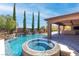 Wonderful pool and spa with water features and covered patio area, perfect for outdoor entertaining at 5410 Serenity Brook Dr, Las Vegas, NV 89149