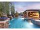 Inviting backyard oasis featuring a sparkling pool, spa, waterfalls, and covered patio area at 5410 Serenity Brook Dr, Las Vegas, NV 89149