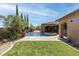 Inviting backyard oasis featuring a pool, spa, water features, and a well-manicured lawn at 5410 Serenity Brook Dr, Las Vegas, NV 89149