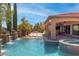 Inviting backyard pool area with a spa, outdoor kitchen, and beautifully landscaped surroundings at 5410 Serenity Brook Dr, Las Vegas, NV 89149