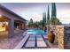 An enchanting swimming pool with waterfalls and greenery, perfect for serene outdoor enjoyment at 5410 Serenity Brook Dr, Las Vegas, NV 89149