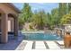 A pristine swimming pool features elegant water features and stone accents, creating a luxurious backyard oasis at 5410 Serenity Brook Dr, Las Vegas, NV 89149