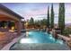 A pool featuring modern landscape and design elements is lit up at dusk at 5410 Serenity Brook Dr, Las Vegas, NV 89149