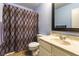 Bathroom featuring blue walls, shower with patterned curtain, and a vanity with sink at 555 Rene Ln, Henderson, NV 89015