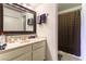 This bathroom includes a single sink vanity with a granite countertop at 555 Rene Ln, Henderson, NV 89015