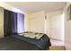 Comfortable bedroom featuring a bed, closet, and door to the hallway at 555 Rene Ln, Henderson, NV 89015