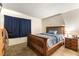 This bedroom features a wooden bed frame, neutral walls, and soft carpeting at 555 Rene Ln, Henderson, NV 89015