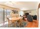 Sunny dining room with a wooden table, chairs, and a view of the living room at 555 Rene Ln, Henderson, NV 89015