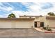 Inviting townhouse with attached garages under a partly cloudy blue sky at 555 Rene Ln, Henderson, NV 89015