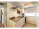 Efficient kitchen with stainless steel sink, white cabinetry, and tiled floor at 555 Rene Ln, Henderson, NV 89015
