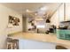 Cozy kitchen showcasing white cabinets, a breakfast bar, and modern appliances at 555 Rene Ln, Henderson, NV 89015