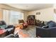 Comfortable living room with tile flooring, recliner seating, and a large window at 555 Rene Ln, Henderson, NV 89015