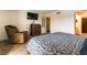Comfortable bedroom with a recliner, dresser, and TV at 555 Rene Ln, Henderson, NV 89015