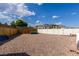 The backyard features a gravel area with fencing, and some small trees, under a bright blue sky at 5865 Egan Crest Dr, Las Vegas, NV 89149